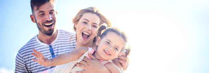 Family group outdoors, capturing a moment of togetherness in a bright, natural setting.